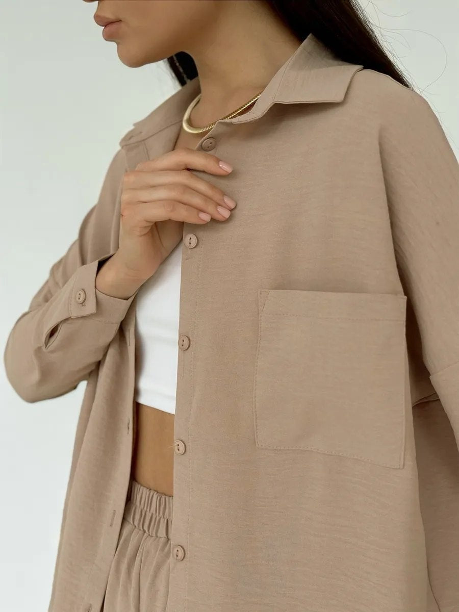 Zweiteiliges Set aus einfarbiger Strickjacke mit Taschen und lässiger, weit geschnittener Hose.