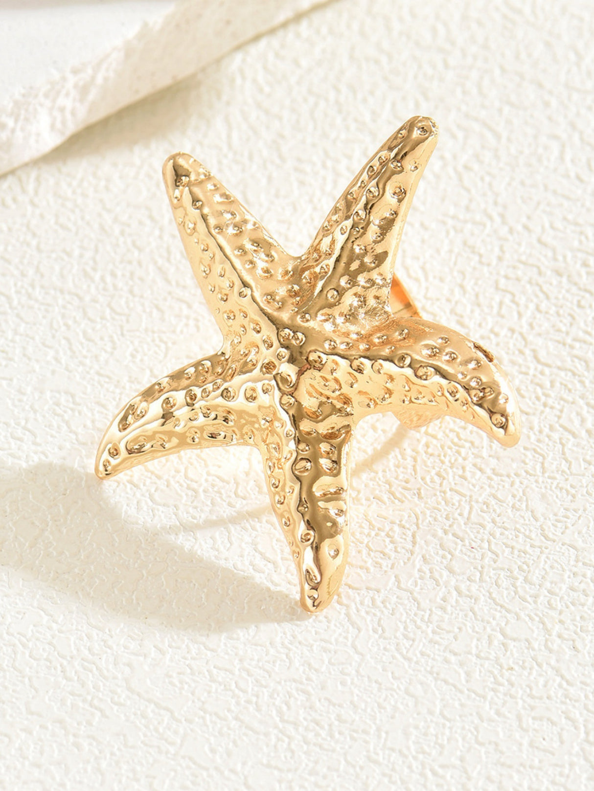 A Ring With An Exaggerated Design Inspired By Conch Shells And Starfish.