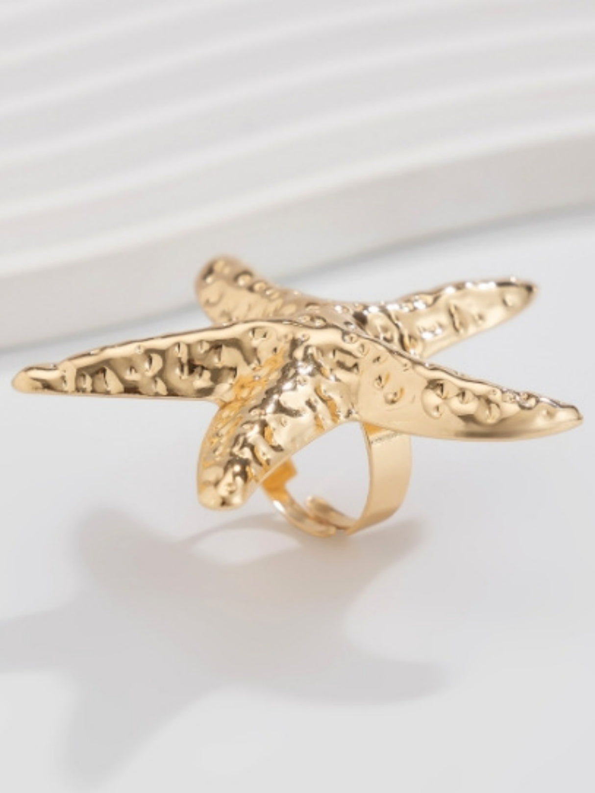 A Ring With An Exaggerated Design Inspired By Conch Shells And Starfish.