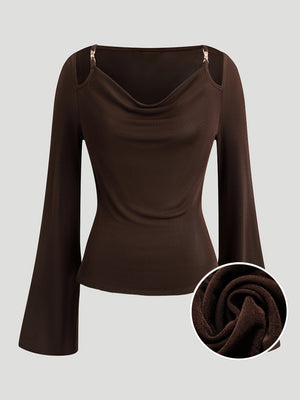 A Fitted Long-sleeved Top With A Flared Neckline And Metallic Shoulder Embellishments.