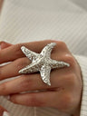 A Ring With An Exaggerated Design Inspired By Conch Shells And Starfish.