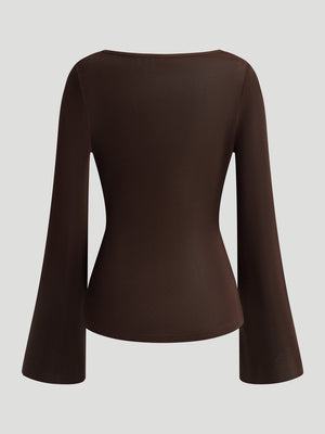 A Fitted Long-sleeved Top With A Flared Neckline And Metallic Shoulder Embellishments.