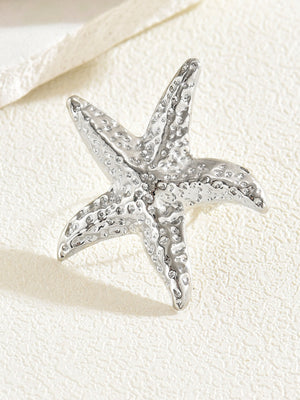 A Ring With An Exaggerated Design Inspired By Conch Shells And Starfish.