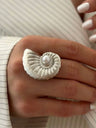 A Ring With An Exaggerated Design Inspired By Conch Shells And Starfish.