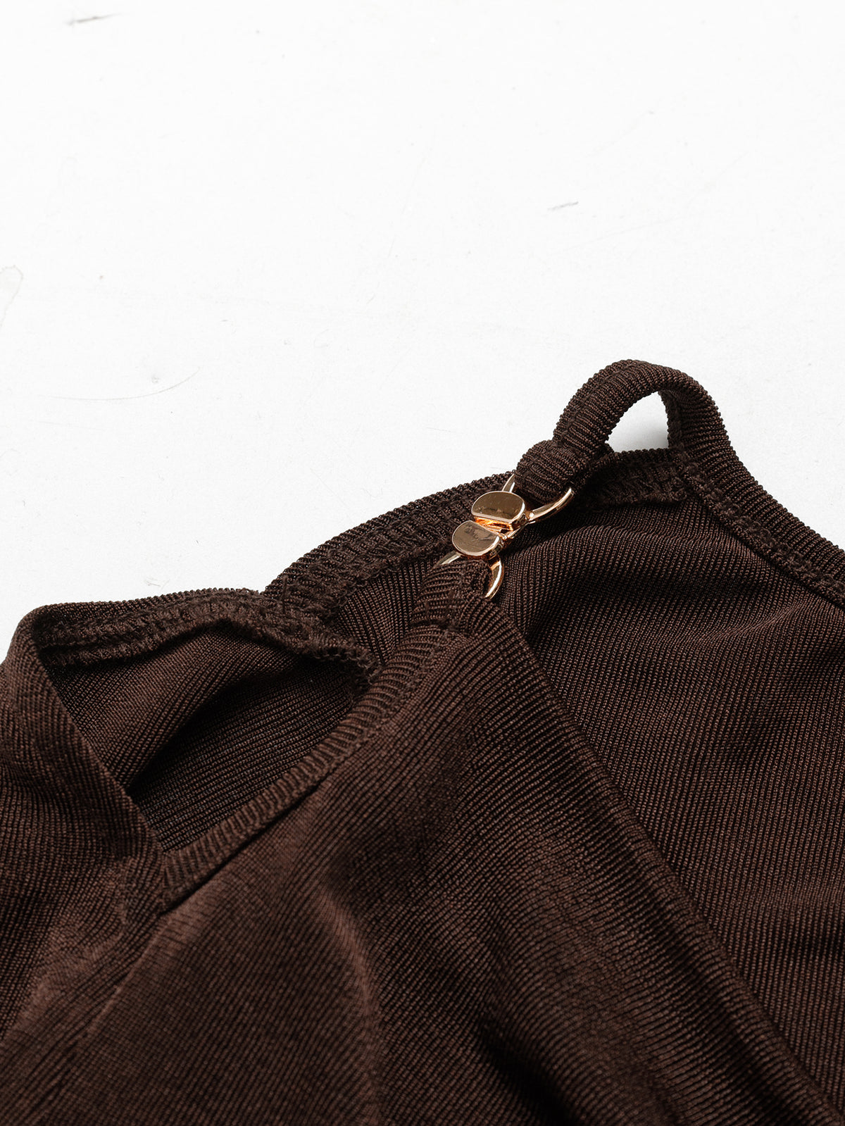 A Fitted Long-sleeved Top With A Flared Neckline And Metallic Shoulder Embellishments.